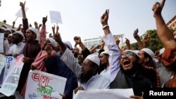Bangladeshi Muslim activists gather in front of Baitul Muqarram National Mosque to protest against deaths of Rohingya Muslims in the Rakhine state of Myanmar, in Dhaka, Bangladesh, Dec. 1, 2016. 