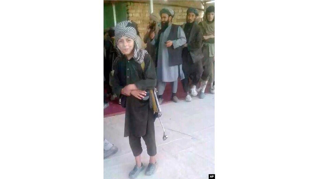 A young Islamic State fighter poses for a journalist after he surrendered to government security forces in the Darzab district of Jawzjan province, north of Kabul, Afghanistan, Aug. 1, 2018.