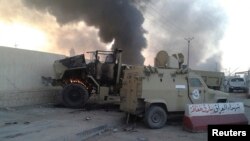 Damaged vehicles belonging to Iraqi security forces are seen during clashes between Iraqi security forces and al-Qaida-linked Islamic State in Iraq and the Levant in Mosul, Iraq, June 10, 2014. 