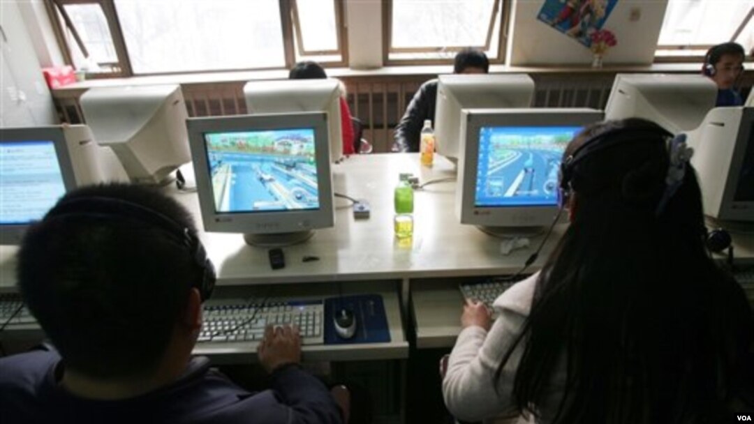 FILE - Users work at computers at an internet cafe in Beijing, Feb. 8, 2007. China remains the world's largest online piracy market.