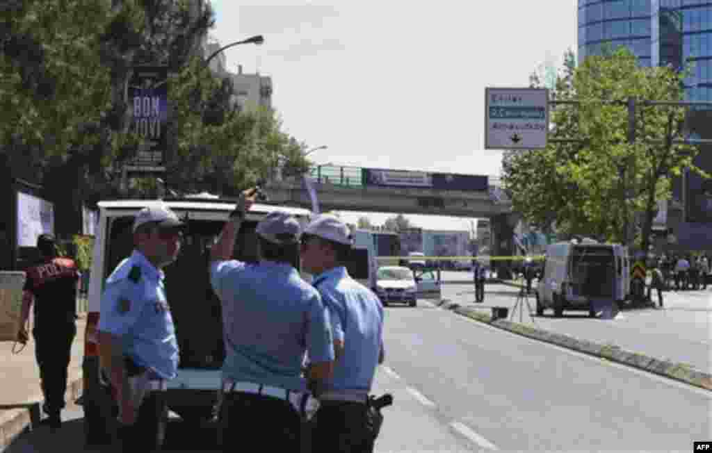 Security members and forensic experts work at the scene after a bomb exploded at a bus stop during rush hour in Istanbul, Turkey, Thursday, May 26, 2011. Seven people were injured as several ambulances rushed to the scene on a multi-lane thoroughfare in a