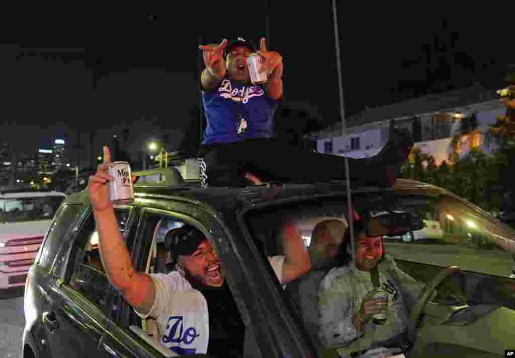 Los Angeles Dodgers fans celebrate on Sunset Blvd. after watching the broadcast of Game 6 of the baseball World Series in Los Angeles, Oct. 27, 2020.