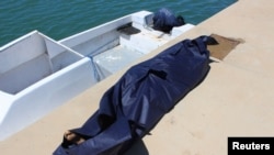 A bag containing the body of a migrant who died after a boat accident off the Libyan coast is seen at Qarabulli town, east of the capital Tripoli, June 2, 2019. 