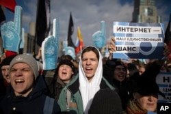 FILE - Demonstrators rally against a bill that envisions an independent Russian internet, essentially cutting users from the global web, in Moscow, Russia, Sunday, March 10, 2019. The placard on the right says "The internet is our only chance."