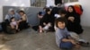 FILE - Wives of former Islamic State fighters sit with their children at a camp for displaced people in Ain Issa, north of Raqqa, Syria, June 21, 2017.