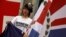 A protester, carrying a former Hong Kong colonial flag, demonstrates against China's intervention and control of the internal affairs of the former British colony, outside the British Consulate in Hong Kong June 15, 2014