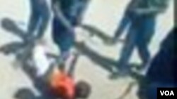 Police are seen in the video beating up the Zimbabwean with tree whips while laughing at the victim. (Photo of the video)