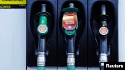 FILE - Fuel pumps are seen at a Shell petrol station in London. 