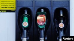 FILE - Fuel pumps are seen at a Shell petrol station in London, Jan. 31, 2013. 