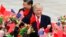U.S. President Donald Trump, right, and Chinese President Xi Jinping are greeted by children waving flowers and flags during a welcome ceremony at the Great Hall of the People in Beijing, Nov. 9, 2017. 