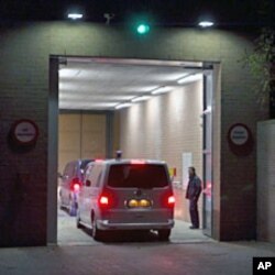 A motorcade of two cars believed to be carrying Ivory Coast's former president Laurent Gbagbo enters the prison in Scheveningen, November 30, 2011