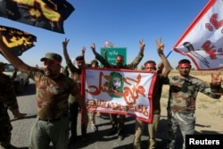 Shi'ite Popular Mobilization Forces celebrate on the outskirts of Kirkuk, Iraq, Oct. 17, 2017.