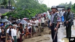 A Myanmar policeman and soldier provide security