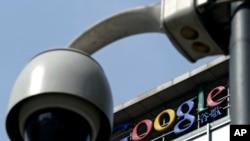 In this file photo from March 23, 2010, a surveillance camera is seen in front of the Google China headquarters in Beijing, China.