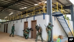 FILE - Ivorian soldiers conduct an urban reconnaissance exercise under the supervision of French special forces at Camp Loumbila, Jacqueville, Ivory Coast, on Feb. 16, 2022. Ivory Coast said on Dec. 31, 2024, that French troops will leave the country in the next month.