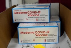 FILE - Boxes containing the Moderna COVID-19 vaccine are prepared to be shipped at the McKesson distribution center in Olive Branch, Miss., Sunday, Dec. 20, 2020. (AP Photo/Paul Sancya, Pool)