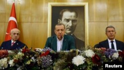 Turkish President Tayyip Erdogan, accompanied by Parliament Speaker Ismail Kahraman and Chief of Staff, General Hulusi Akar, speaks during a news conference at Ataturk airport in Istanbul, Turkey, Sept. 17, 2017.