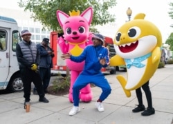 Pinkfong and Baby Shark cheer on the Washington Nationals with fans of all ages ahead of Game 3 of the World Series, while gifting WowWee's official Baby Shark toys at various landmarks in Washington.