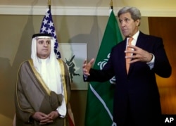 U.S. Secretary of State John Kerry, right, gestures next to Saudi Foreign Minister Adel al-Jubeir, left, during a meeting on Syria in Geneva, Switzerland, May 2, 2016.
