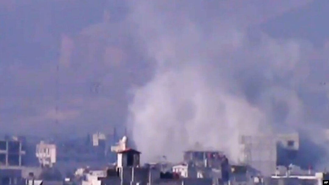 In this image from video obtained from the Shaam News Network, smoke rises due to shelling in the Damascus countryside, Jan. 2, 2013.