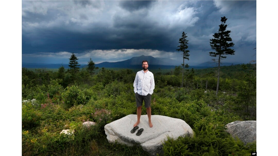 FILE - Lucas St. Clair, the son of Burt's Bees founder Roxanne Quimby, poses on land proposed for a national park in Penobscot County, Maine, Aug. 4, 2015.