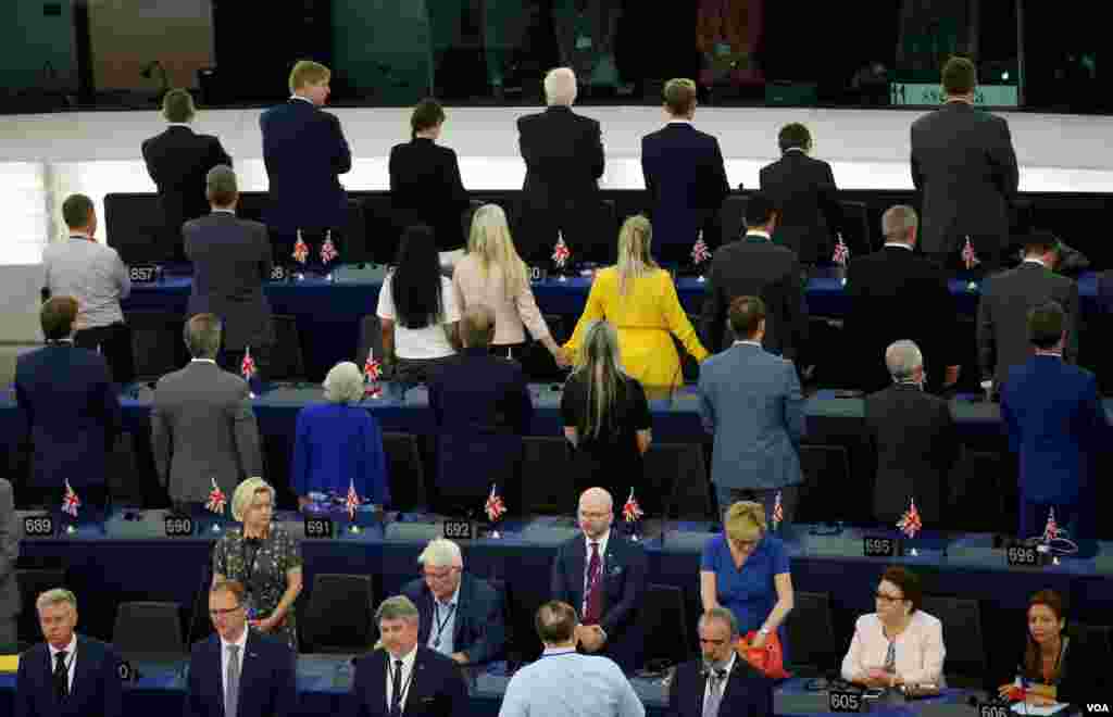 Members of the Brexit Party turn their back to the assembly as the European anthem is played, during the first plenary session of the newly elected European Parliament in Strasbourg, France.