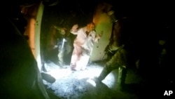 A video image from a helmet camera shows U.S. and Iraqi special forces freeing hostages from a prison controlled by Islamic State militants in the town of Huwija, Iraq, Oct. 22, 2015.