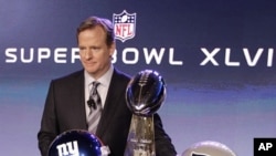 NFL Commissioner Roger Goodell poses with the Vince Lombardi Trophy after a news conference in Indianapolis, Feb. 3, 2012.