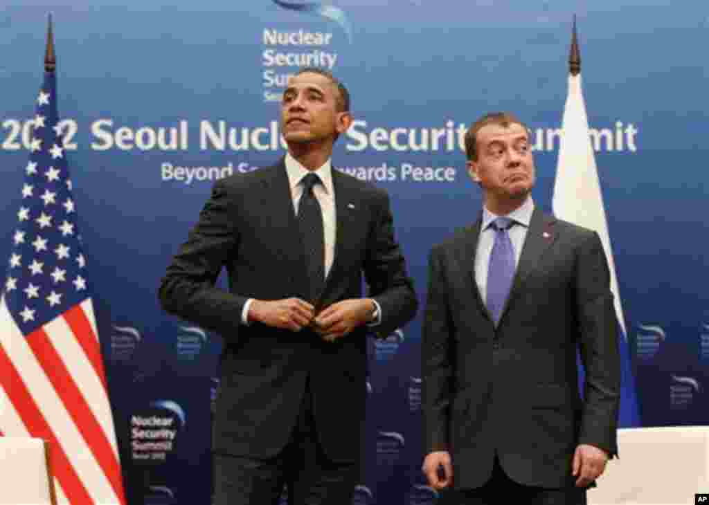 U.S. President Barack Obama, left, and Russian President Dmitry Medvedev stand together at the end of a bilateral meeting at the Nuclear Security Summit in Seoul, South Korea, Monday, March 26, 2012. (AP Photo/Pablo Martinez Monsivais)