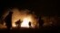 Locals work to contain a wild fire in the Chapada dos Veadeiros National Park in Goias state, Brazil, Oct. 28, 2017. Hundreds of men and women have joined forces with firefighters to help control the wildfire that has ravaged more than a quarter of the national park. 