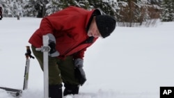  Frank Gehrke, chief of the California Cooperative Snow Surveys Program for the Department of Water Resources, checks the snowpack depth as he conducts the first snow survey of the season at Phillips Station in Echo Summit, California, Jan. 3, 2017.