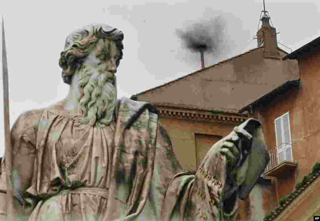 Black smoke emerges from the chimney on the Sistine Chapel as cardinals voted on the second day of the conclave to elect a pope in Saint Peter&#39;s Square at the Vatican, March 13, 2013. 