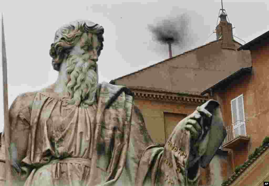 Black smoke emerges from the chimney on the Sistine Chapel as cardinals voted on the second day of the conclave to elect a pope in Saint Peter's Square at the Vatican, March 13, 2013.