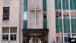 A man walks by the offices of the Diocese of Rockville Centre, in Rockville Centre, N.Y., Oct. 1, 2020.
