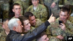 U.S. Vice President Mike Pence poses for photos with troops at Bagram Air Base in Afghanistan, Dec. 21, 2017.