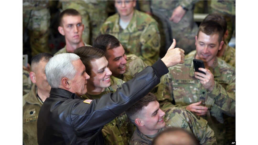 U.S. Vice President Mike Pence poses for photos with troops at Bagram Air Base in Afghanistan, Dec. 21, 2017.