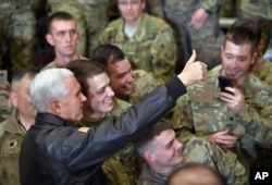 U.S. Vice President Mike Pence poses for photos with troops at Bagram Air Base in Afghanistan, Dec. 21, 2017.