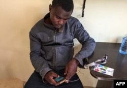 Ismail Olamilekan, a 21-year-old young Nigerian, sits in his room at a hostel in Moscow, July 12, 2018.