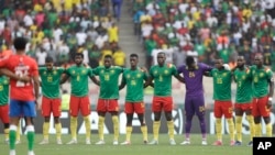 Cameroon players observe a minute of silent for the victims of the stampede, before the start of the African Cup of Nations 2022 quarter-final soccer match between Gambia and Cameroon at the Japoma Stadium in Douala, Cameroon, Jan. 29, 2022.