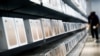 A man browses an iPhone unit on display at a section selling Apple's products together with Chinese made electric appliances at a hypermarket in Beijing, Thursday, May 9, 2019. 