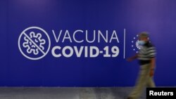 Un hombre camina dentro de un centro de vacunación contra la enfermedad por coronavirus (COVID-19) en San Salvador, 13 de abril de 2021.