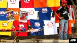 A peddler offer t-shirts with images of late Venezuelan President Hugo Chavez in front of the Military Academy in Caracas, Mar. 14, 2013. 