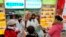 Staff sell masks at a Yifeng Pharmacy in Wuhan, Chin, Jan. 22, 2020. 