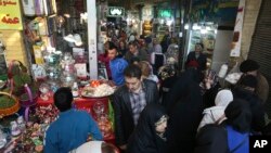 FILE - People shop ahead of the Iranian New Year, or Nowruz, meaning "New Day" at the Tajrish traditional bazaar in northern Tehran, Iran, March 13, 2019.