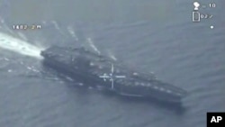 FILE - A still image made from video broadcast on Iranian State television purports to be drone footage of a U.S. aircraft carrier.