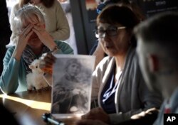 Sex abuse survivor Bernadette Howell, from Canada, left, cries as she listens to Evelyn Korkamaz, another survivor, during a press conference of members of the ECA (Ending Clergy Abuse), in Rome, Feb. 22, 2019.