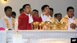 In this photo released by Henan Catholic, Rev. Joseph Zhang Yinlin, second left, takes part in an ordination ceremony to be named coadjutor bishop of Anyang, in Anyang city in central China's Henan province, Aug. 4, 2015.