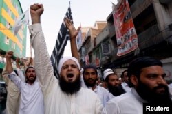 Supporters of the Muttahida Majlis-e-Amal (MMA), a coalition between religious-political parties, chant slogans against, what they say is alleged rigging by Election Commission of Pakistan (ECP) during general election, in Peshawar, Pakistan, July 27, 201