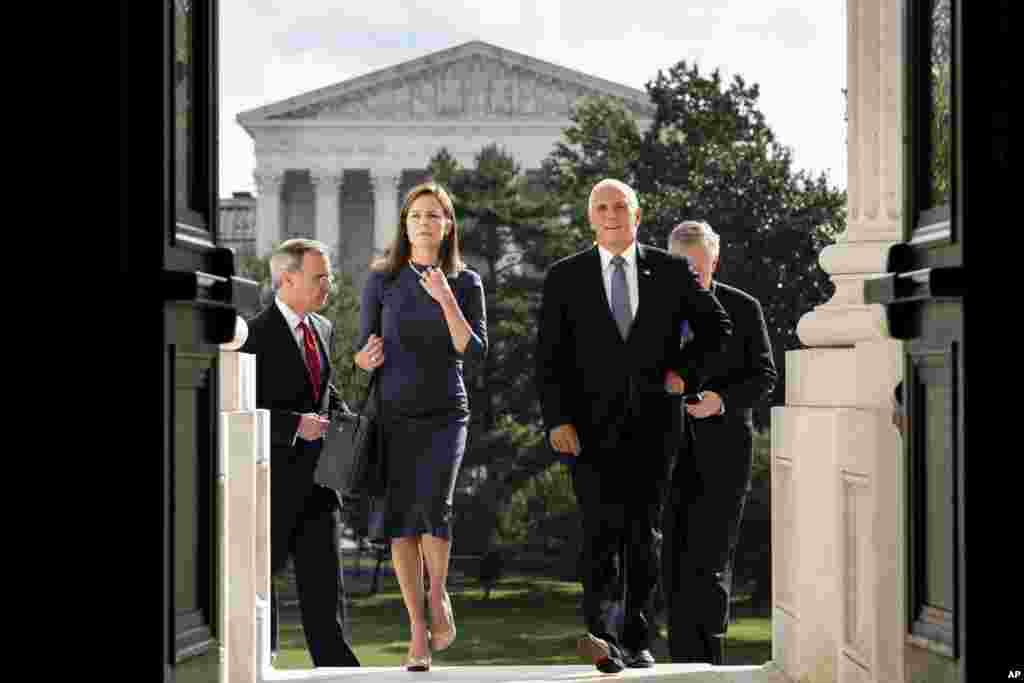 Judge Amy Coney Barrett, President Donald Trump&#39;s nominee to the Supreme Court, left, and Vice President Mike Pence arrive at the Capitol where she will meet with Senators in Washington, D.C.