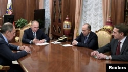 Russia's President Vladimir Putin, second from left, Foreign Minister Sergei Lavrov, left, Director of Russian Federal Security Service Alexander Bortnikov, second from right, and Director of Foreign Intelligence Service Sergei Naryshkin hold a meeting at the Kremlin in Moscow, Dec. 19, 2016. 